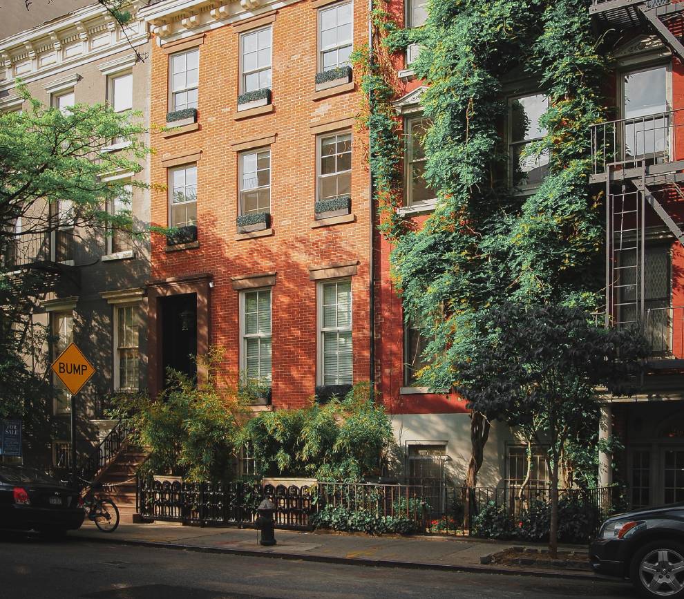 A street with many trees and buildings on the side