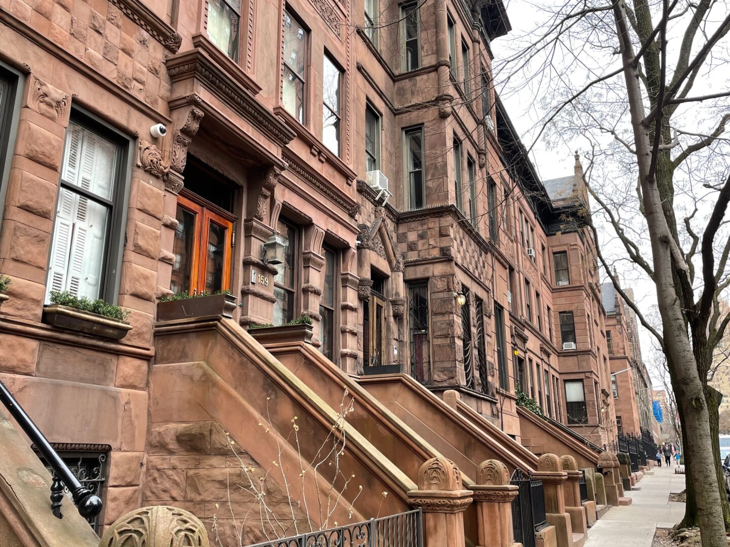 A row of brick buildings with steps leading to the top.